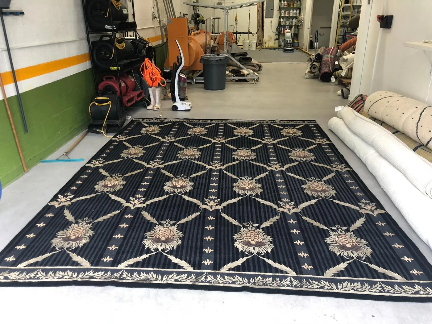 Cleaned rug spread flat across the plant floor