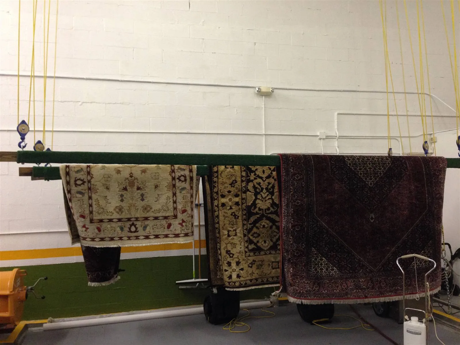 Rugs hung on a rack to dry evenly inside the plant